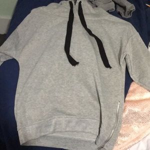 A medium light grey hoodie with a zipper.